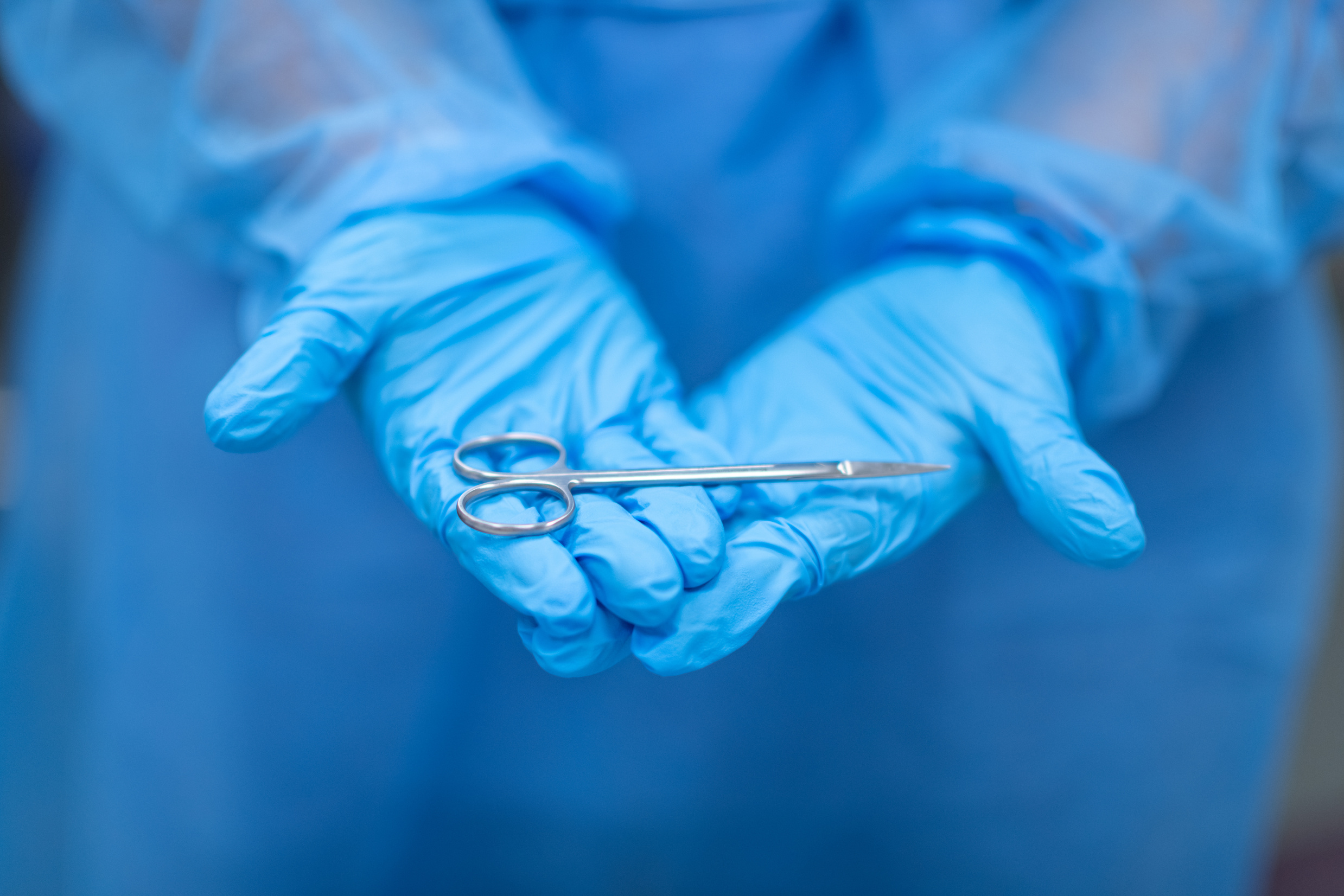Surgeon holding surgical scissors